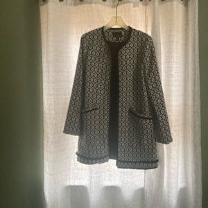 Longer black print sweater.  Two pockets. Nice piece to compliment an outfit